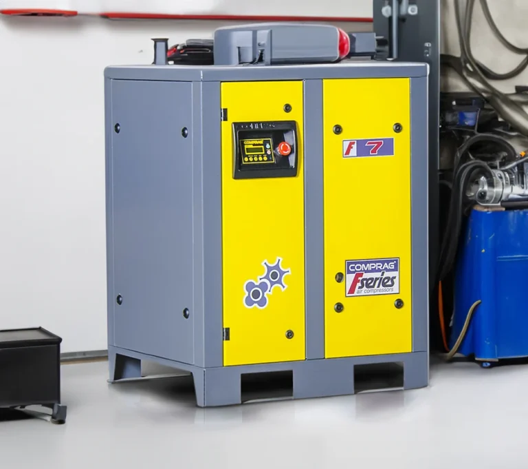 Gul och grå industriell luftkompressormaskin i verkstadsmiljö, märkt Comprag F-serien.
